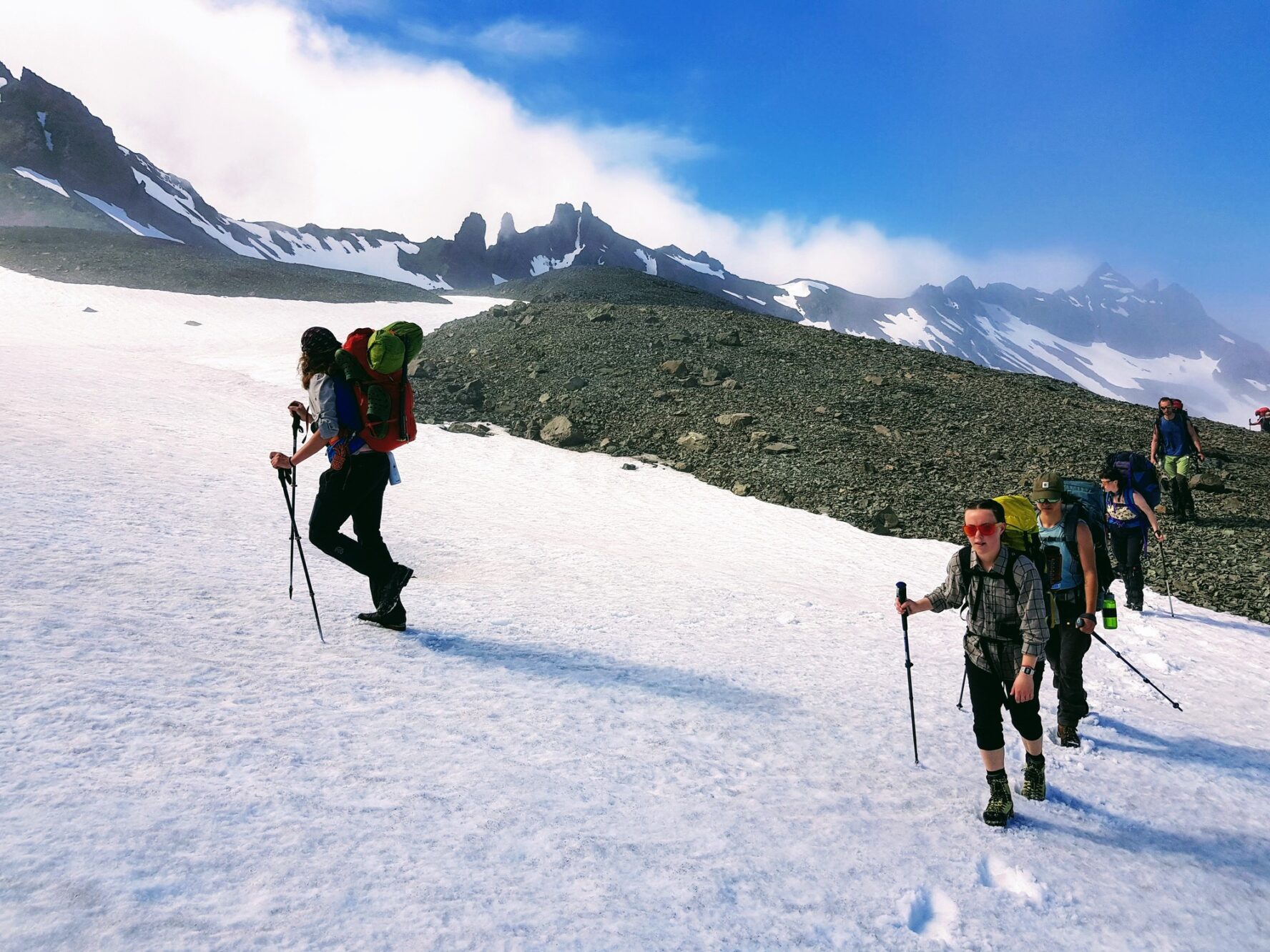 Hikers on a snowpatched mountain in Iceland.