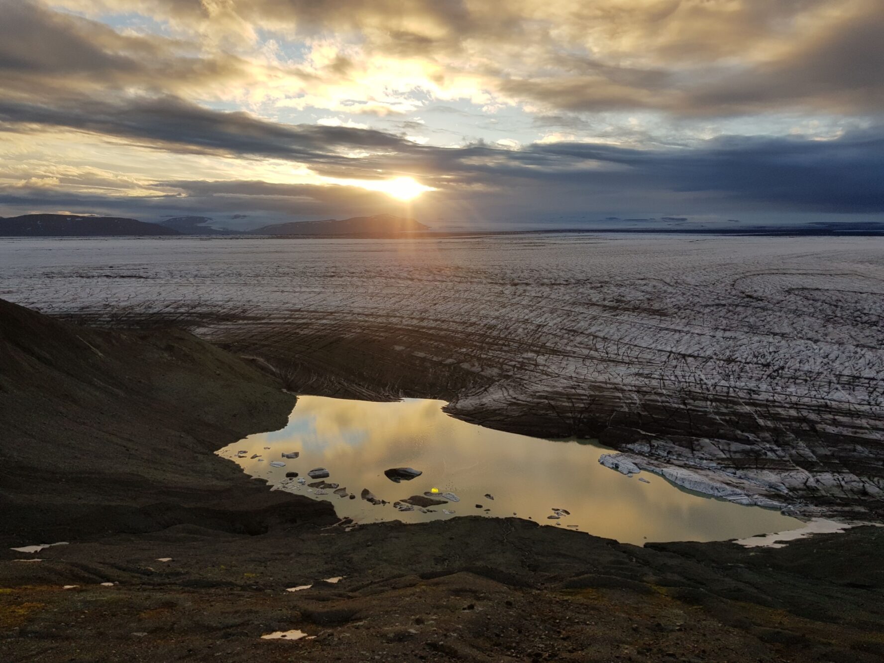 Camping spot above an outlet glacier in the Vatnajokull National Park, Iceland, during sunset.