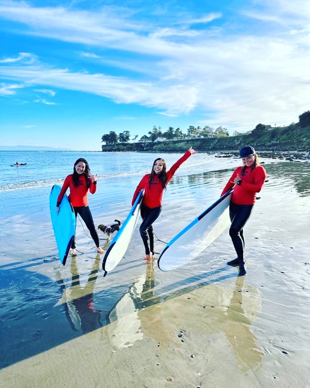 Three happy surfers in the Bay Area
