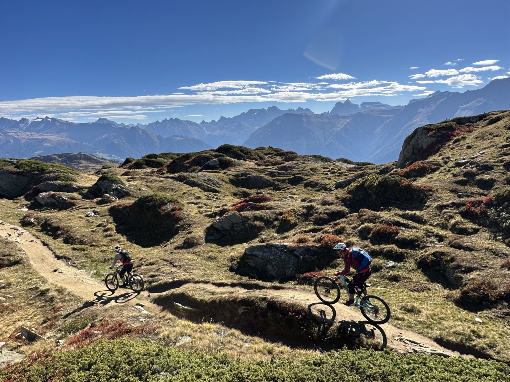 Two mountain bikers riding in the Swiss Alps