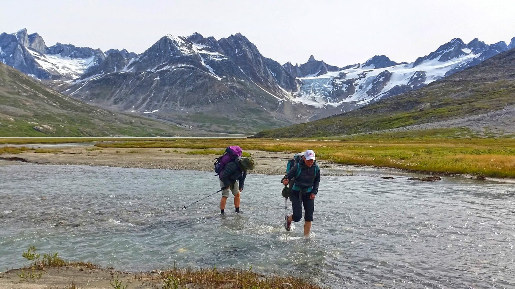 Hikers crossing the river in Greenland