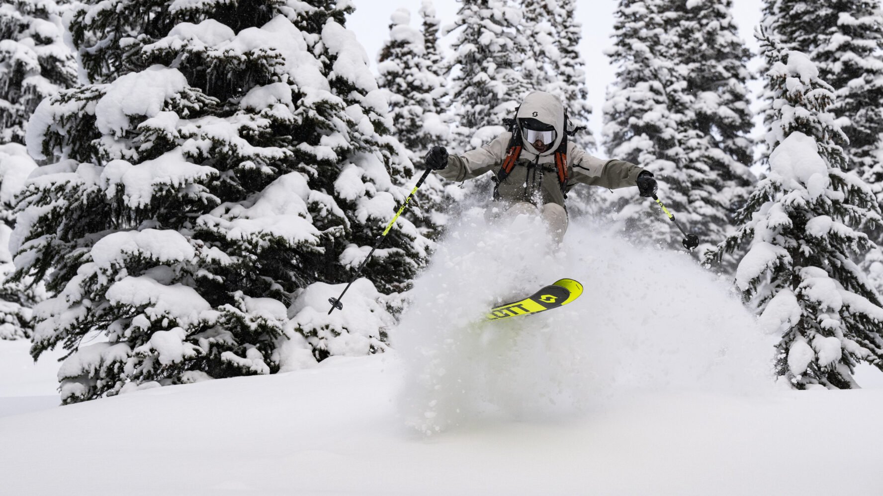 A backcountry skier enjoying powder during a heli-accessed ski touring adventure near Golden, BC.