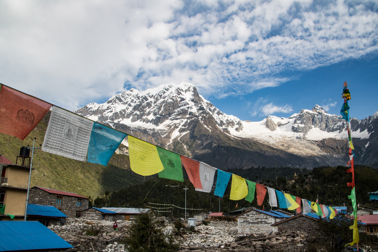 Mount Manaslu from Shayalagaun. Early morning View with prayers flags. Manaslu, Nepal. The Killer Mountains.