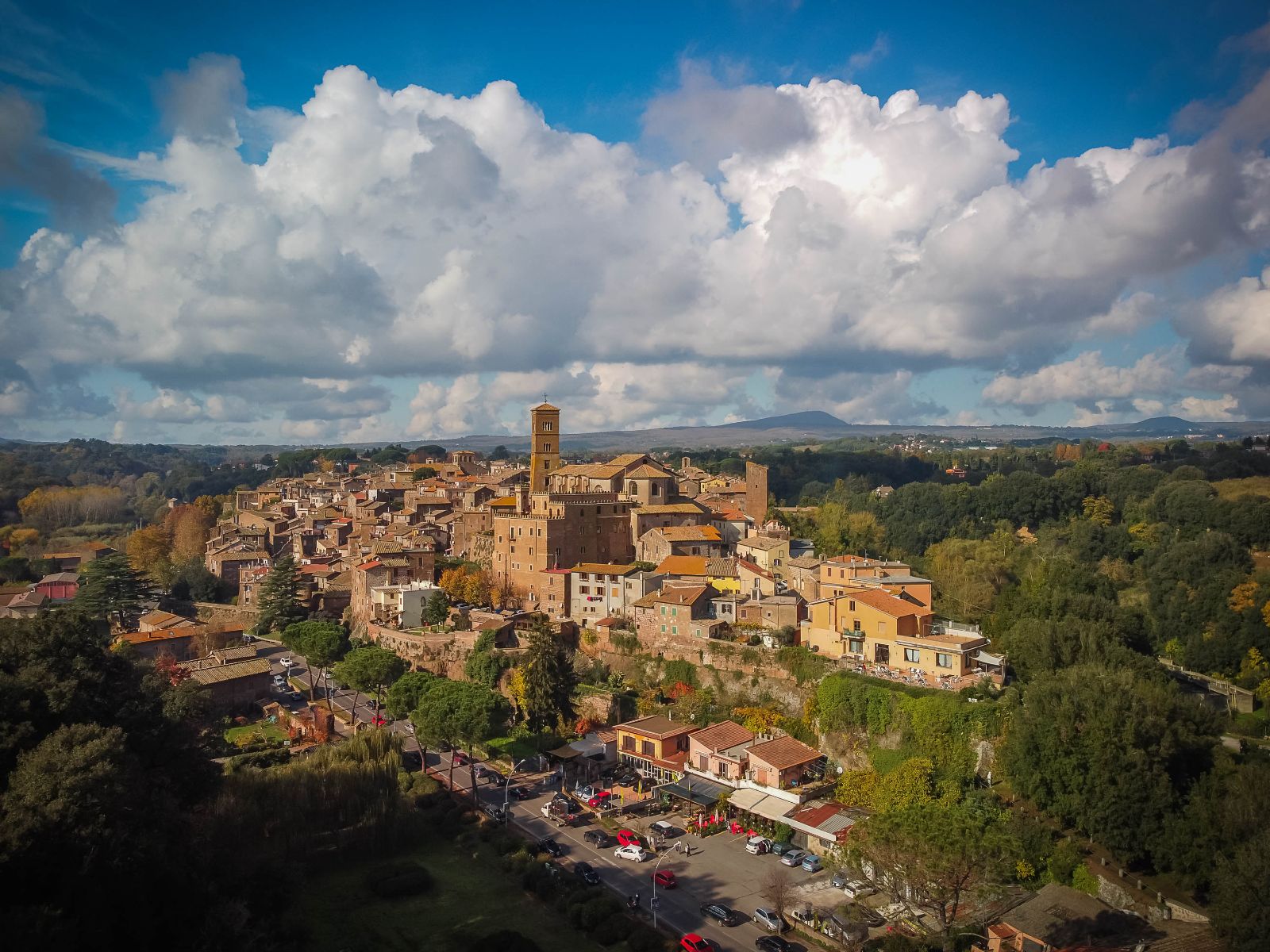 Italian town of Sutri, with a tall bell tower, seen during the Via Francigena walk.