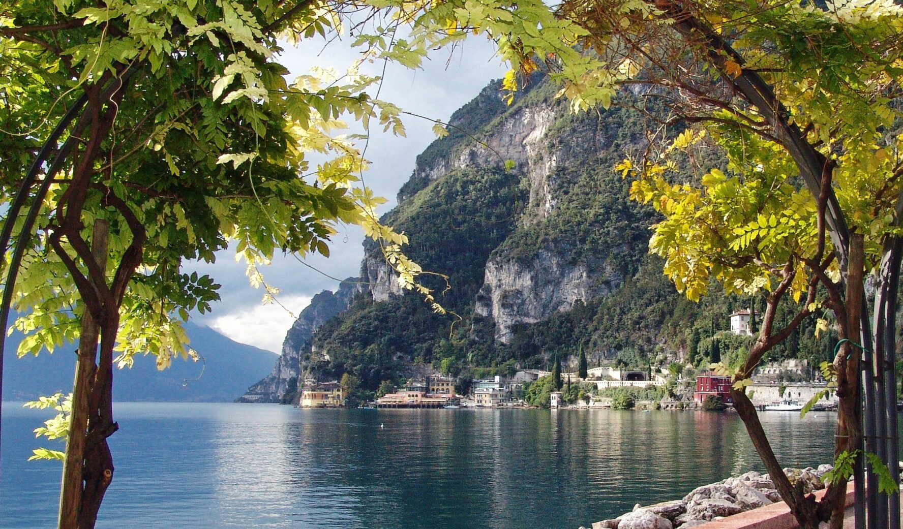 Dramatic lake shoreline and a charming village, seen during the walking holidays of lakes Como, Maggiore, and Garda.