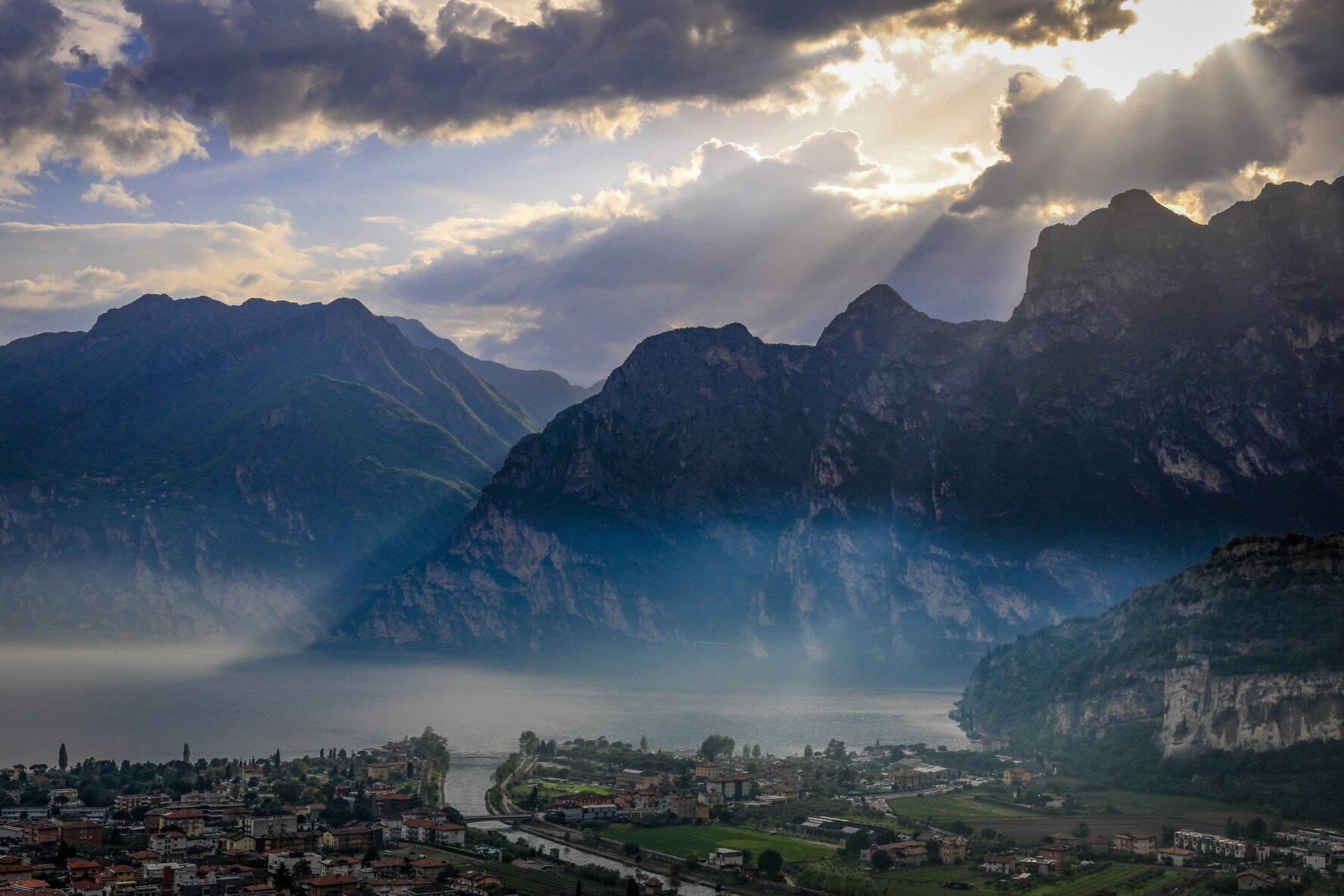 Dramatic mountains above a lakeside town in Northern Italy, seen during the walking holidays of Italy’s great lakes.