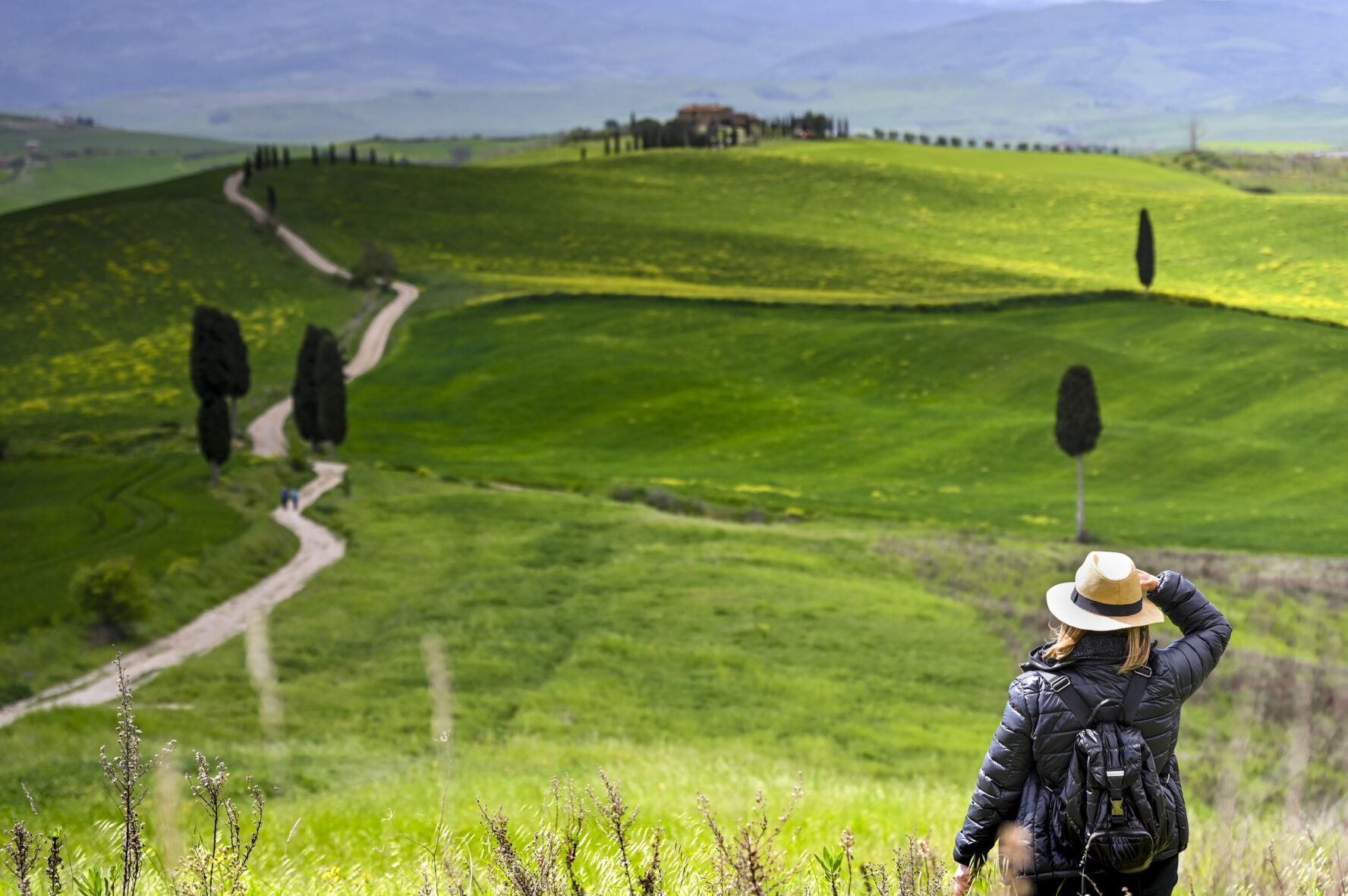 A hiker in Val d’Orcia, Tuscany, Italy.