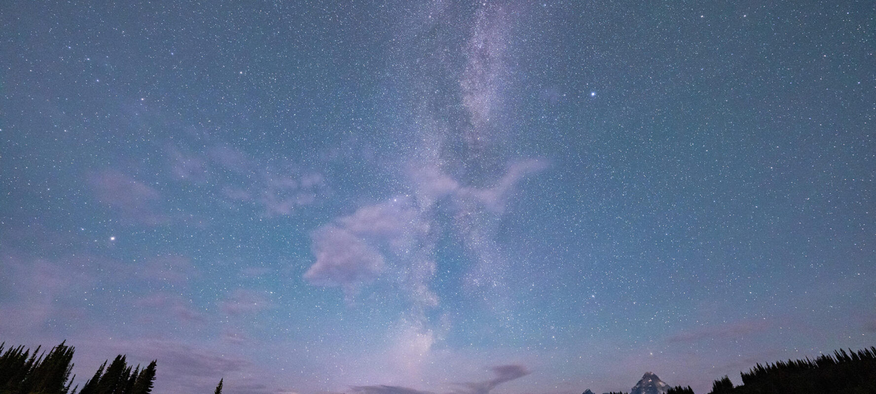 Night sky as seen in BC’s backcountry during summer, with a lot if stars and the Milky Way visible.