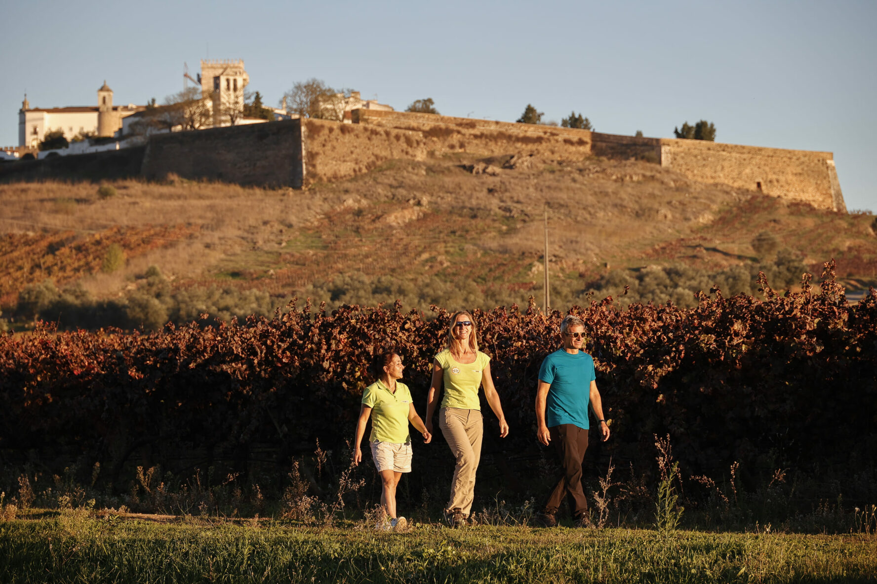 Three hikers at sunset in Portugal