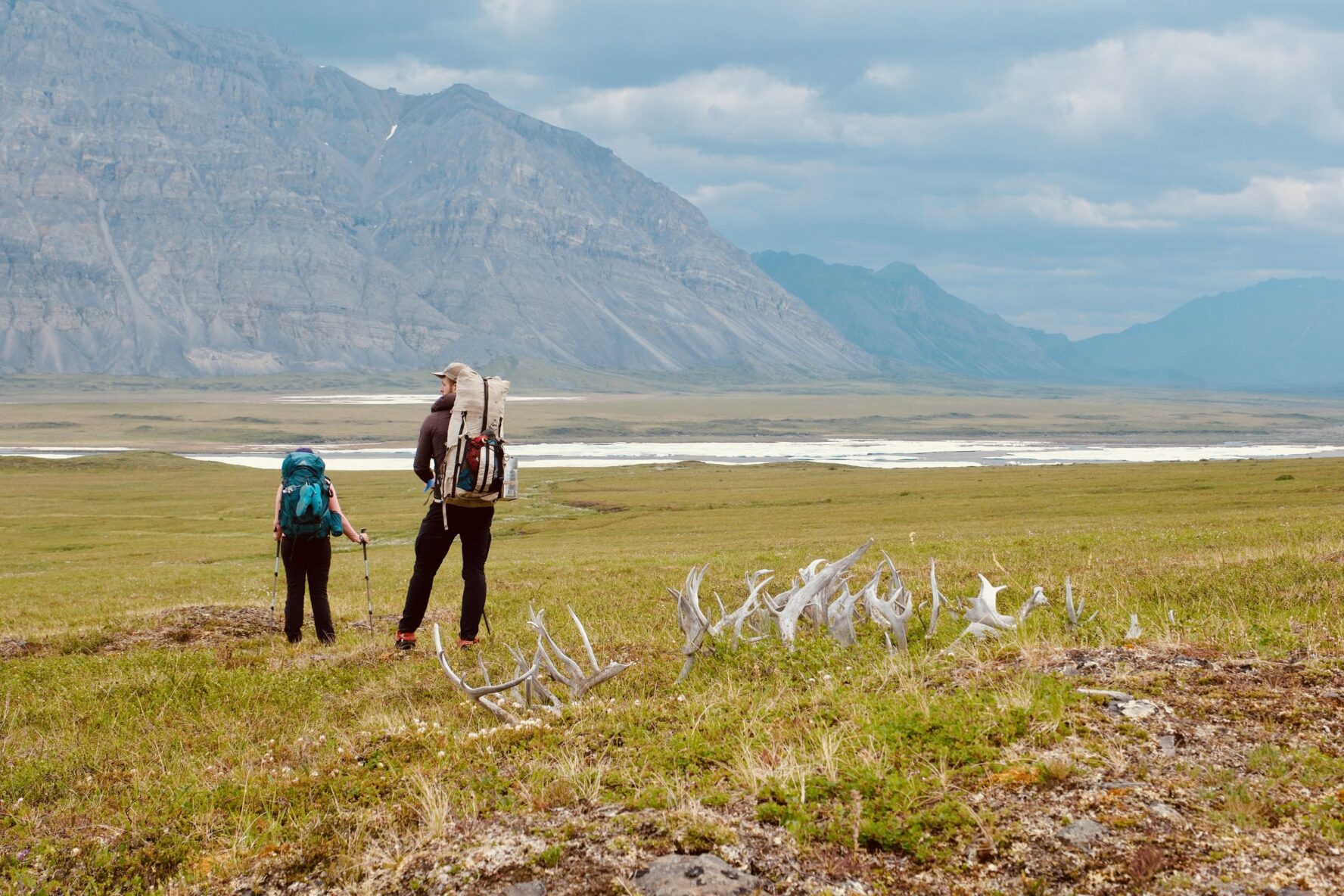 Two hikers and antlers