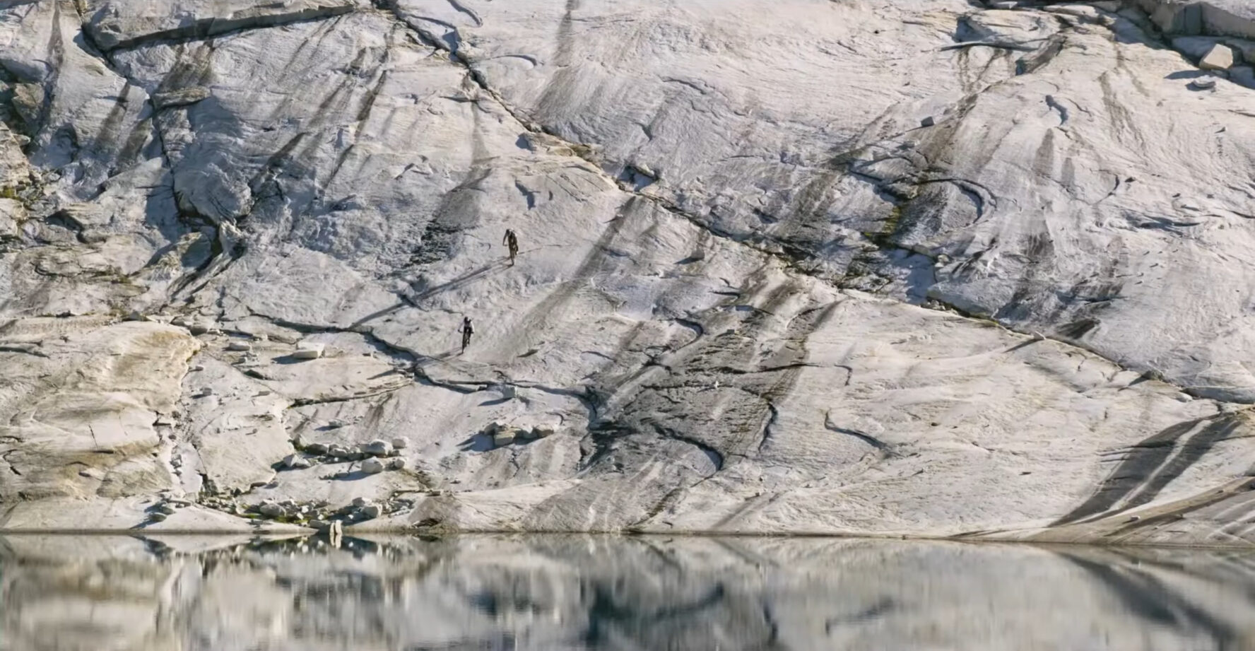MTBers approaching a lake while mountain biking in British Columbia’s Coast Mountains.