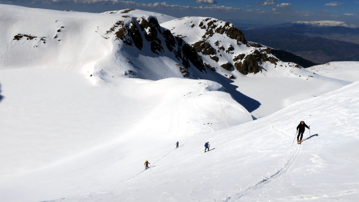 Four skiers in Rila Lakes, Bulgaria
