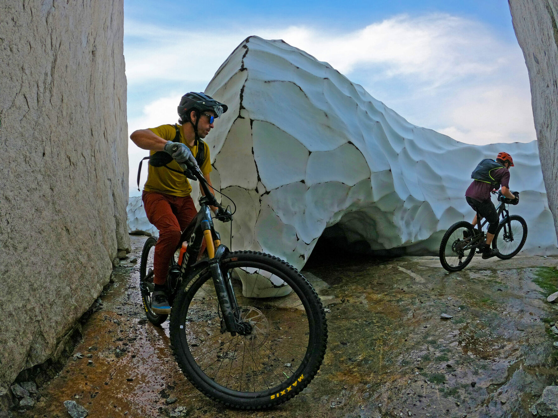 MTBers near a small glacier in BC’s Coast Mountains.