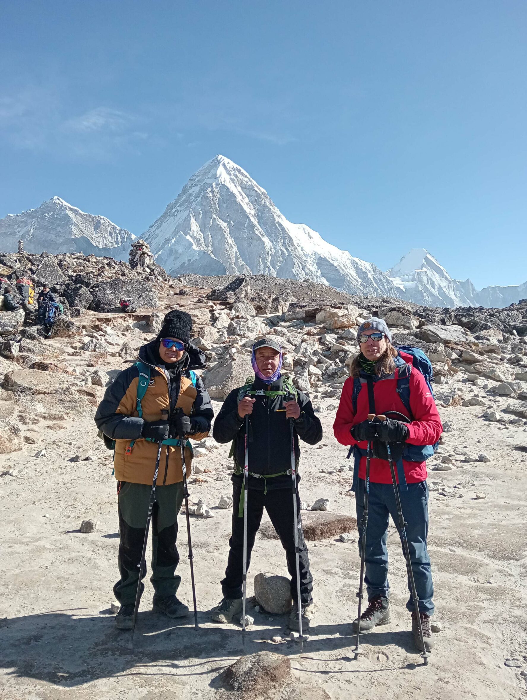 Happy trekkers posing to the backdrop of Mount Everest.