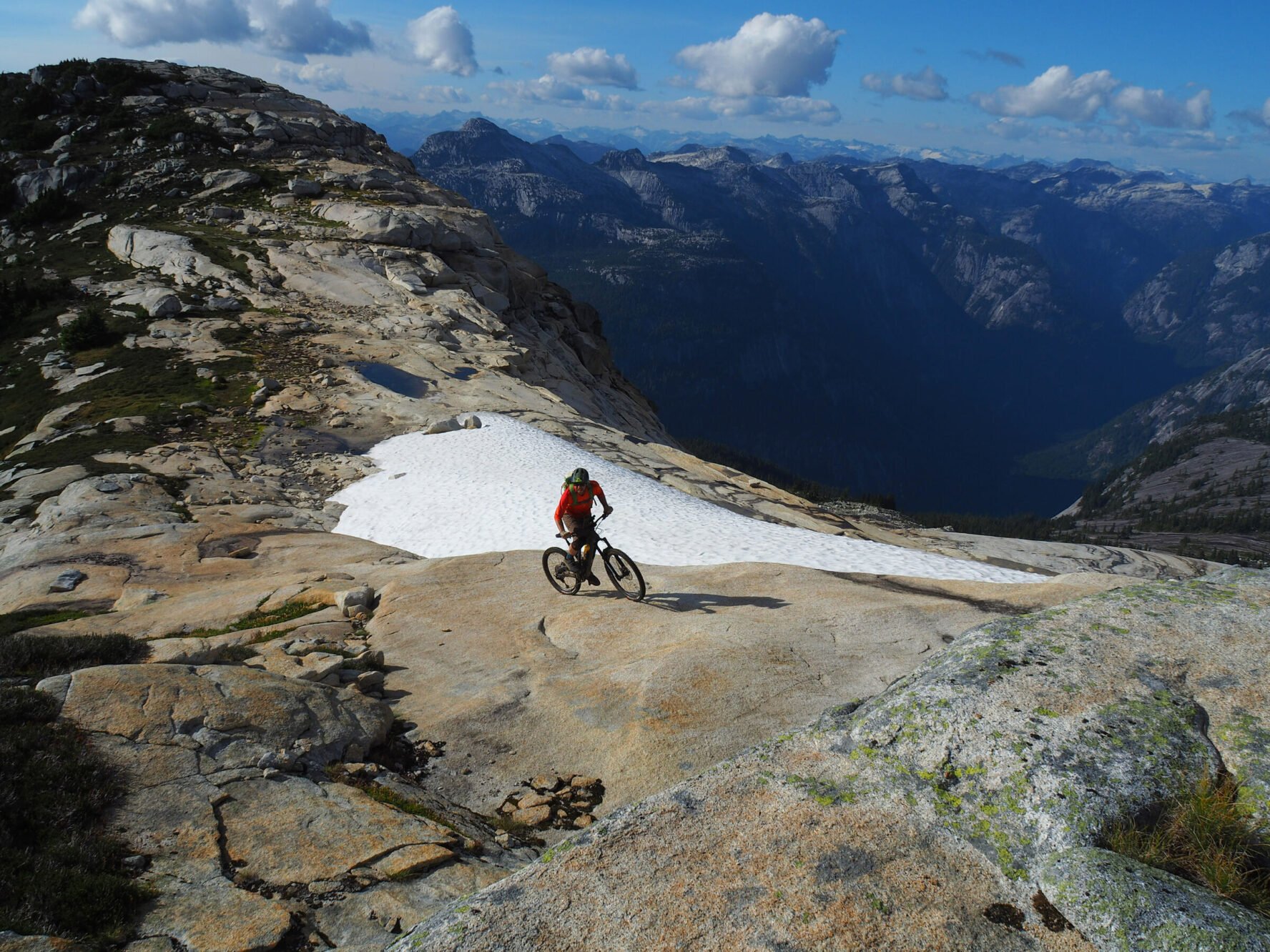 Mountain biker riding surrounded by incredible landscapes of BC’s Coast Mountains.