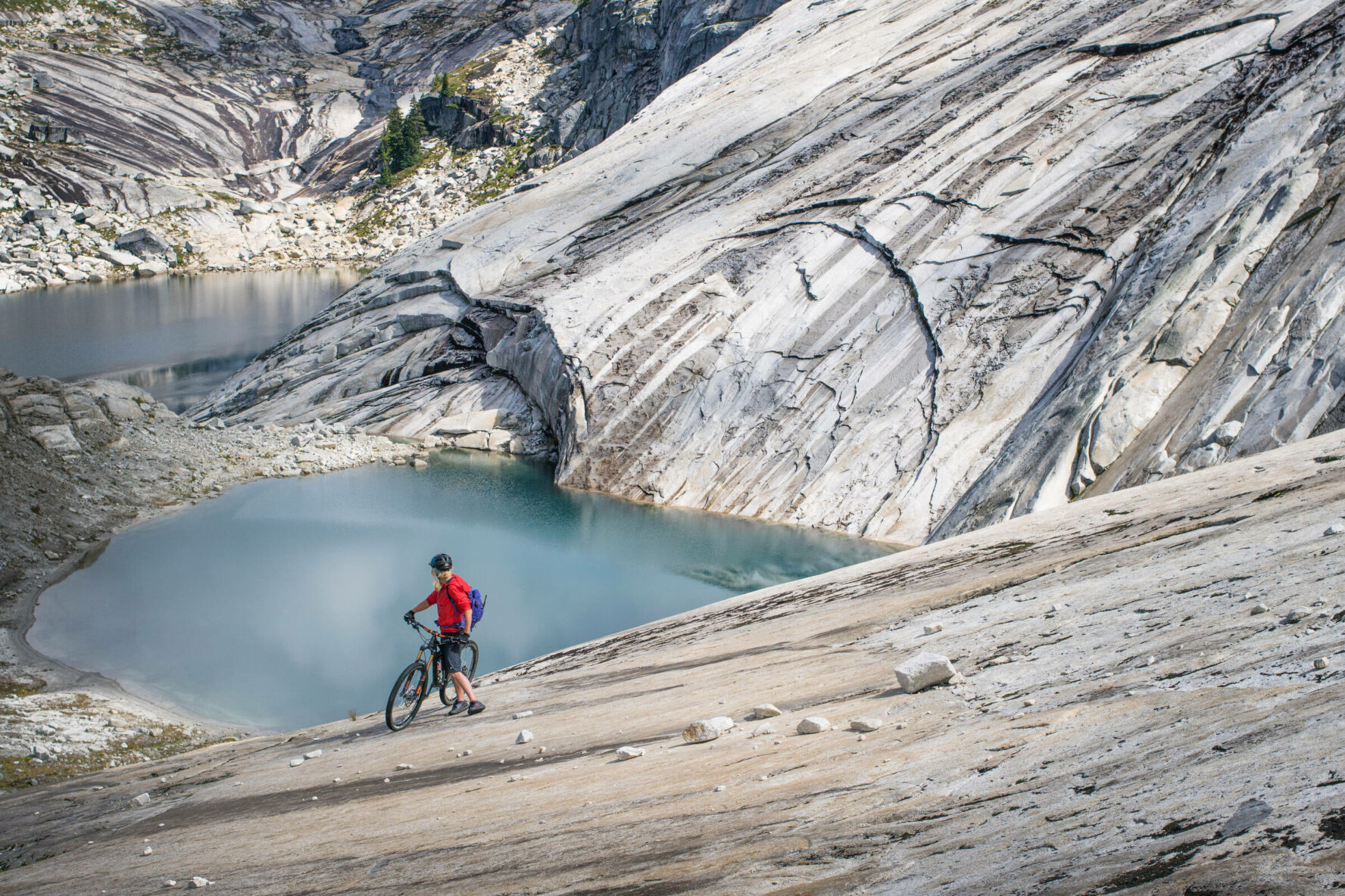 MTBer near a small lake in BC’s Coast Mountains.