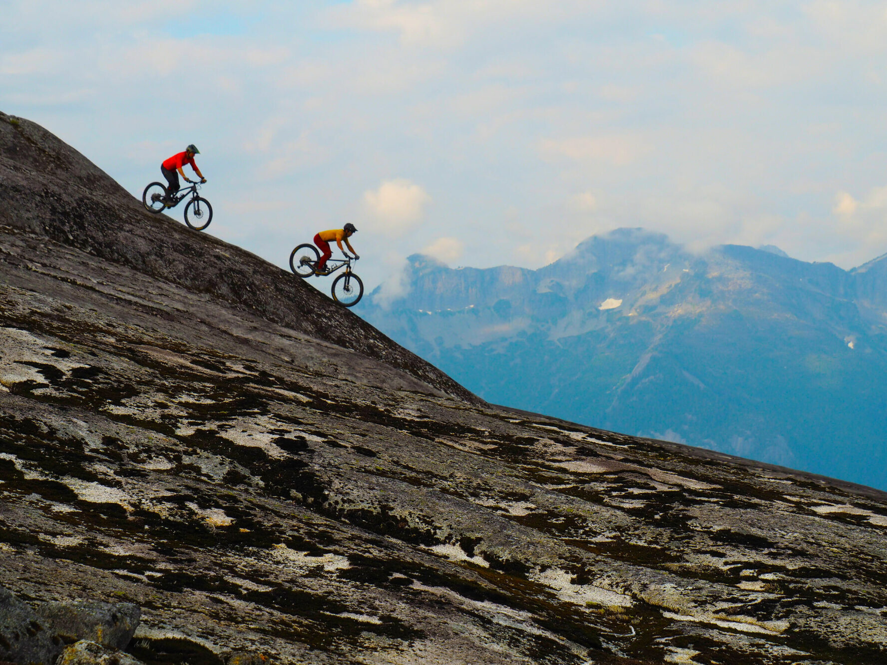 Mountain bikers navigating a long decent while on a MTB tour in British Columbia, Canada.