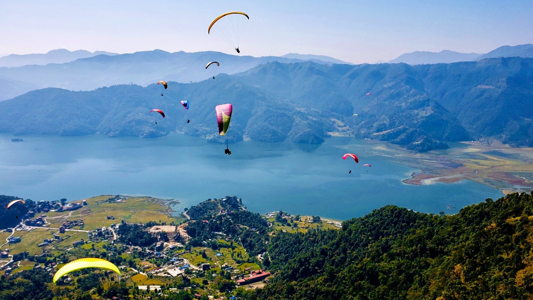 Paragliders in Pokhara, above Phewa lake, Nepal.