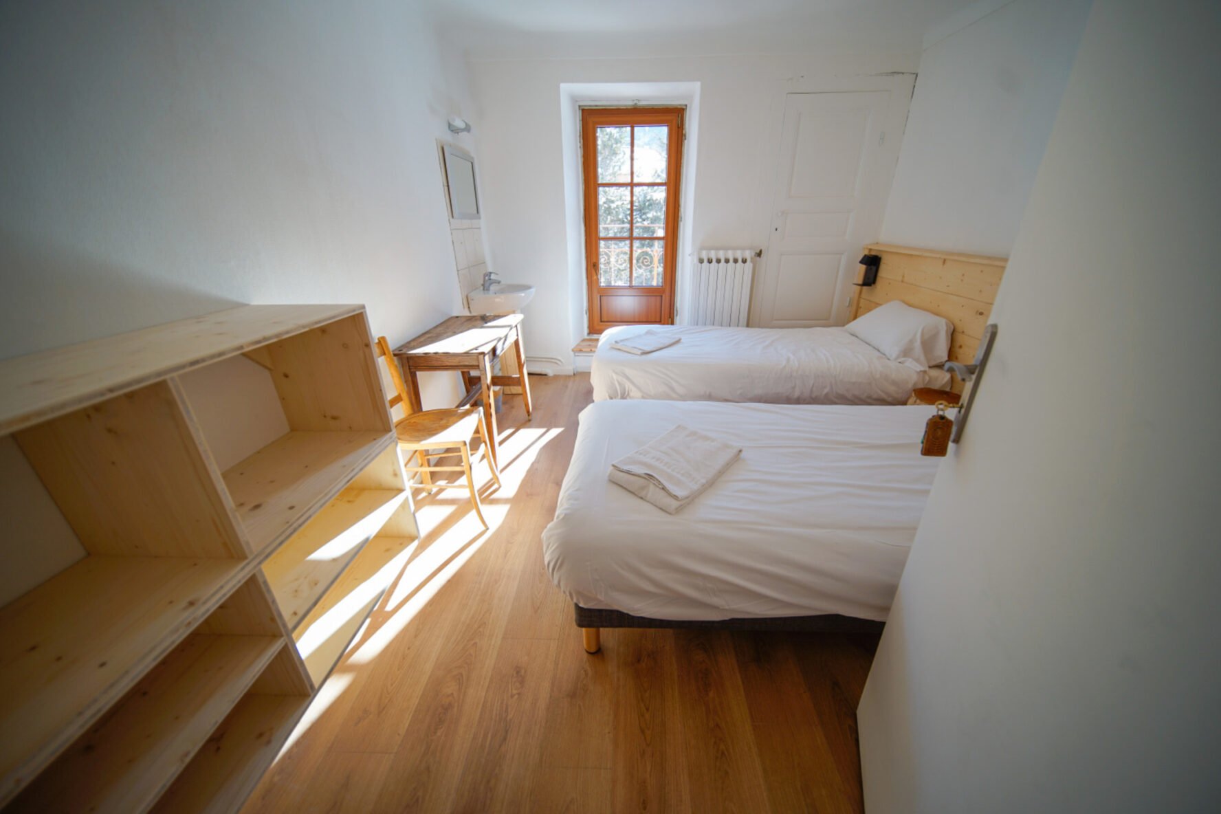 Room with two beds in an Alpine lodge.