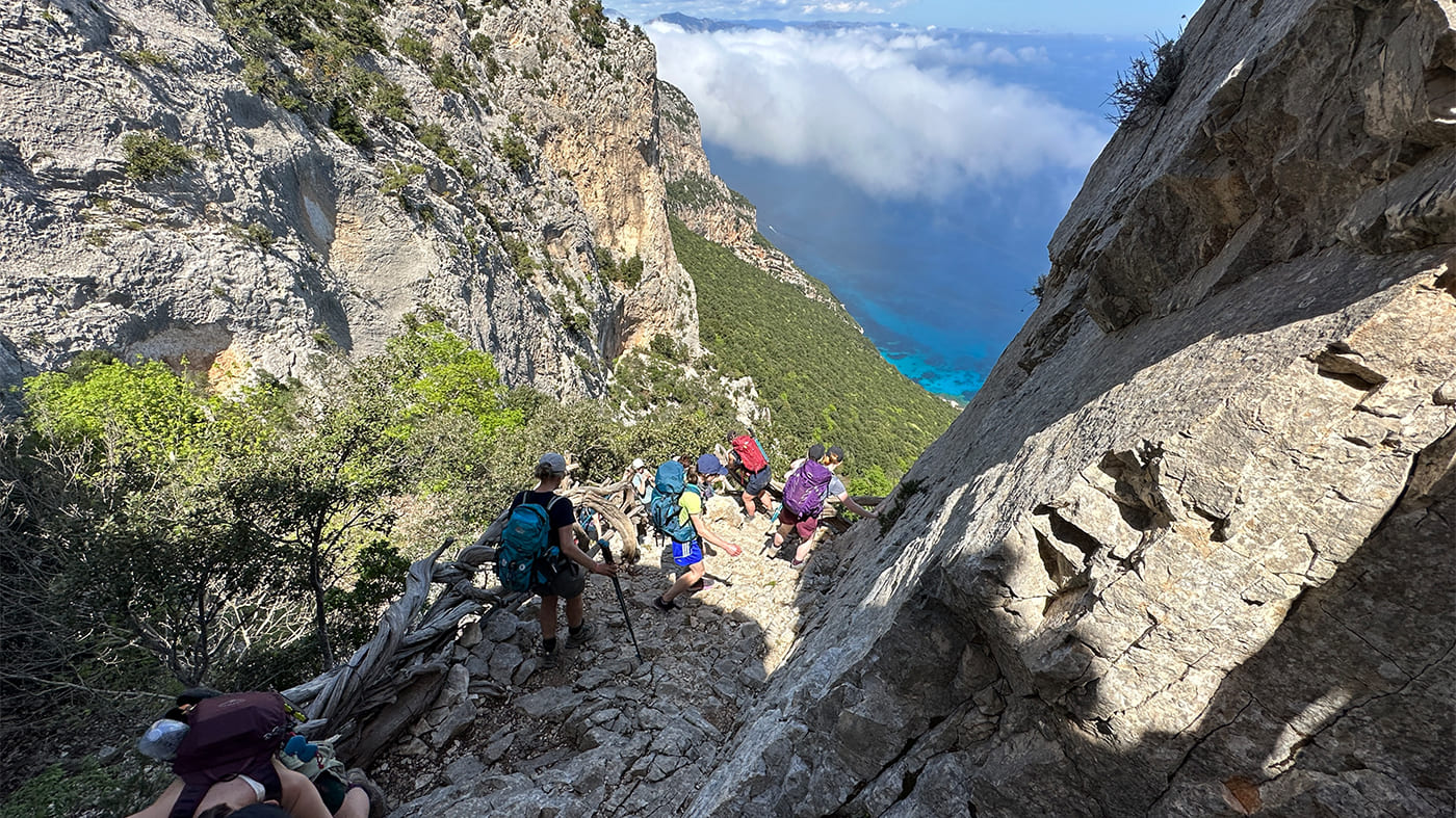 Rugged coast in Sardinia and hikers