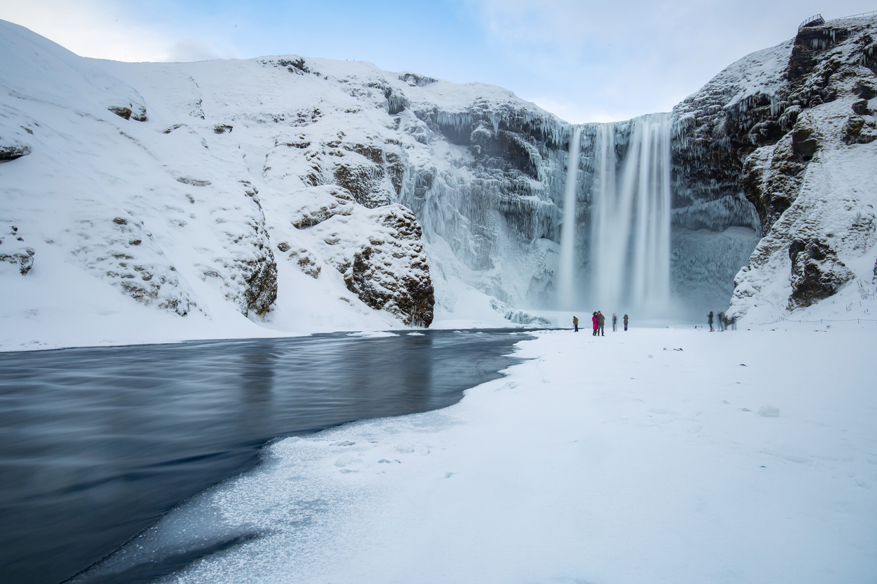 Famous skogafoss Waterfall in iceland on a winter day with some tourists arround.Famous skogafoss Waterfall in iceland on a winter day with some tourists arround.