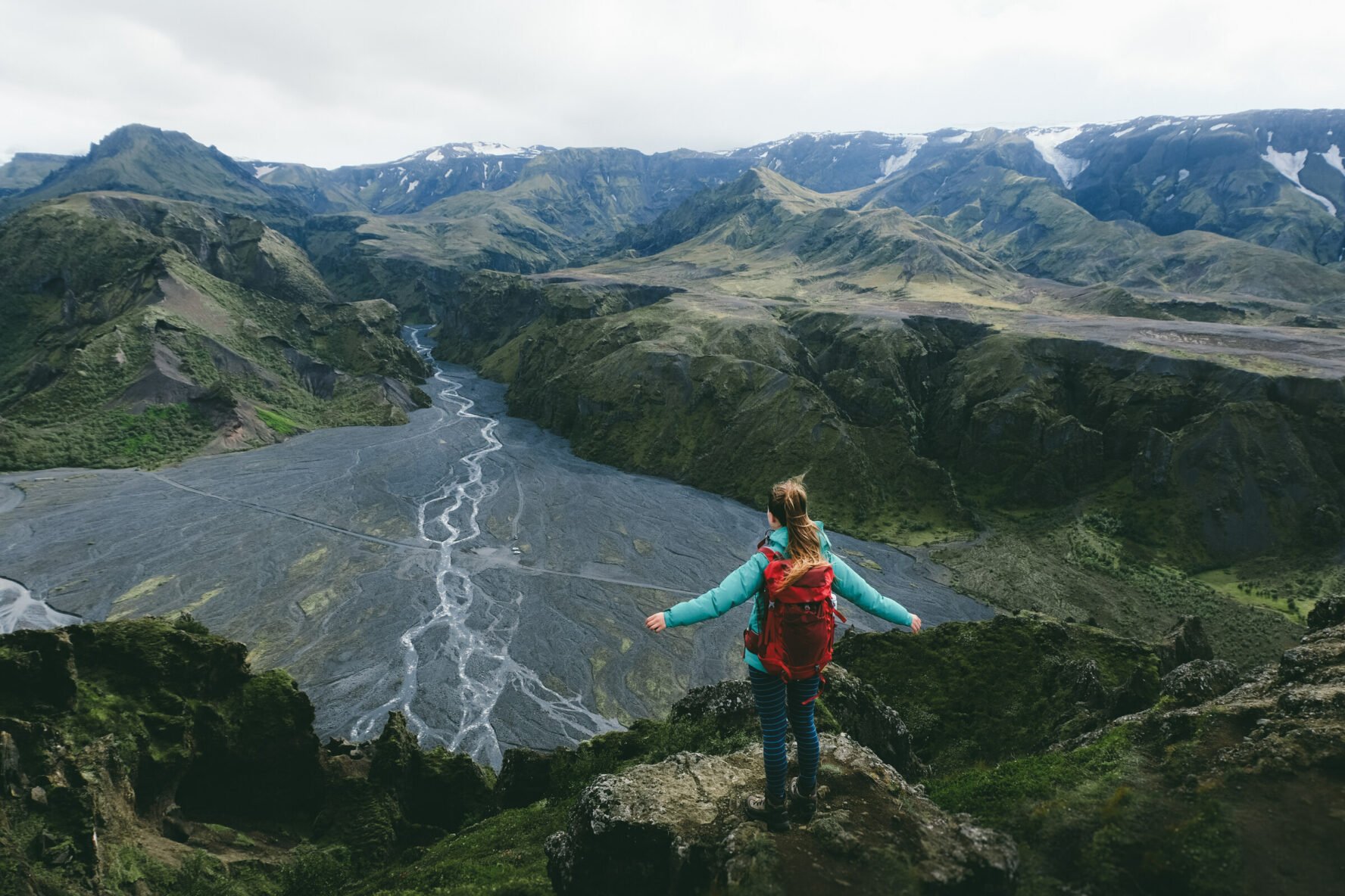 Hiker enjoying epic Thorsmork views from top of the Valahnukur mountain, Iceland.
