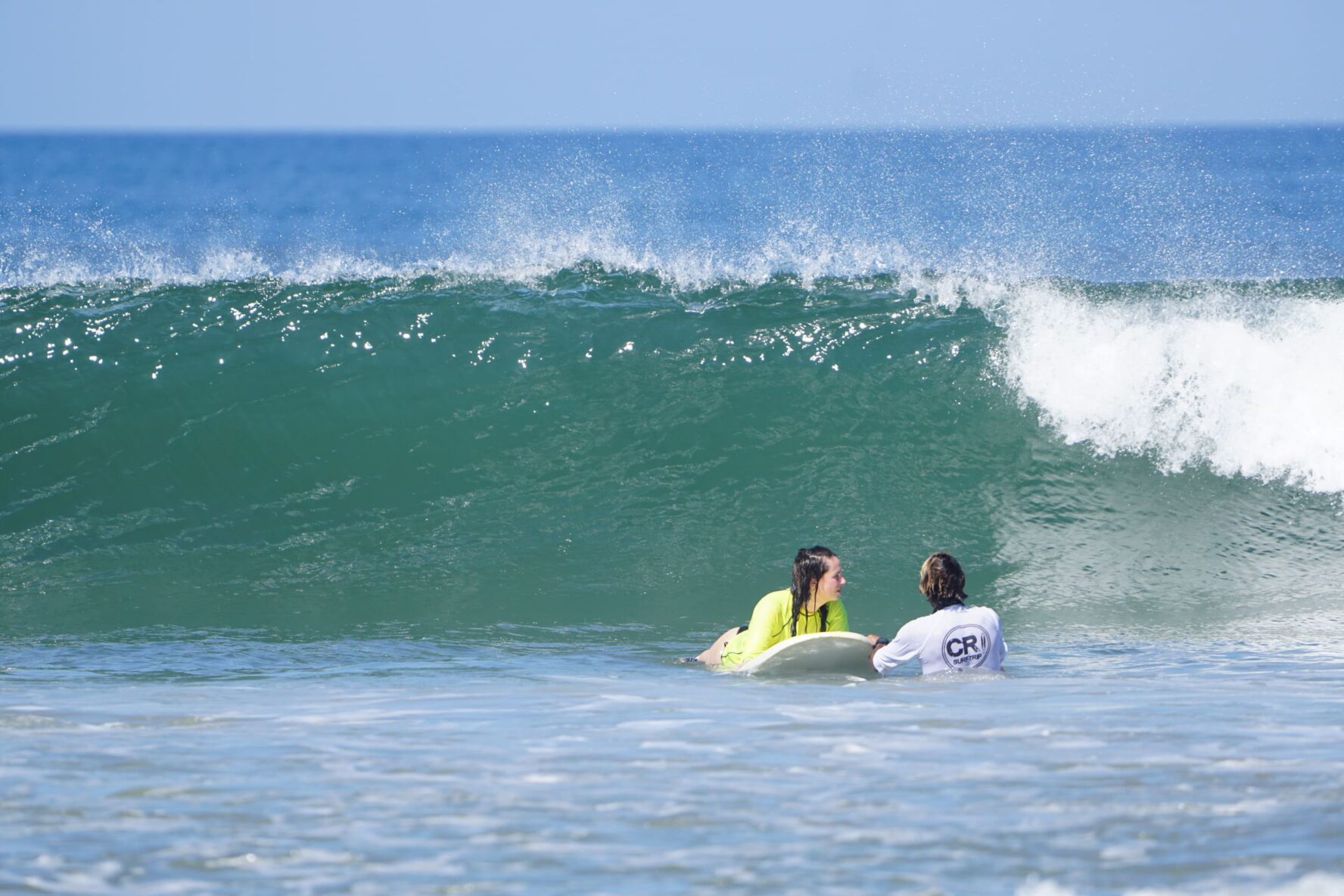 Instructor and student surf lessons