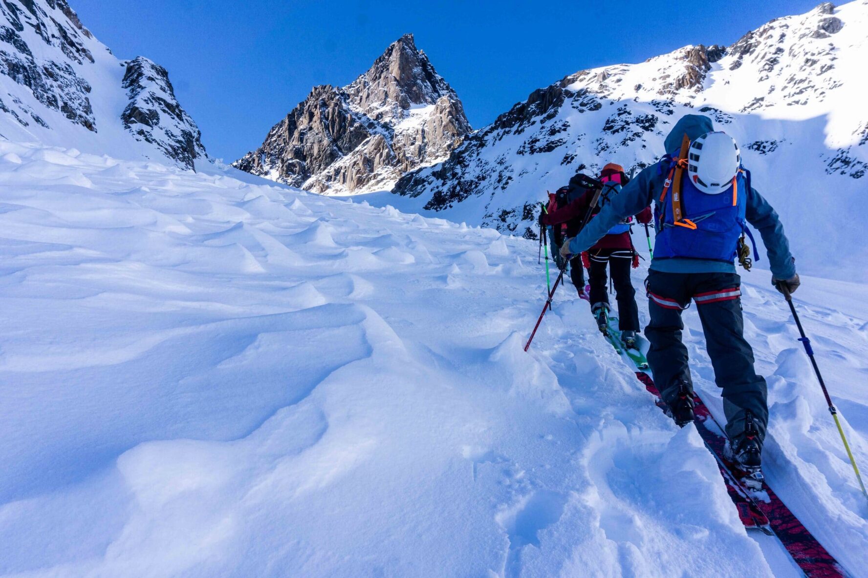 Skiers climbing a peak in West Greenland