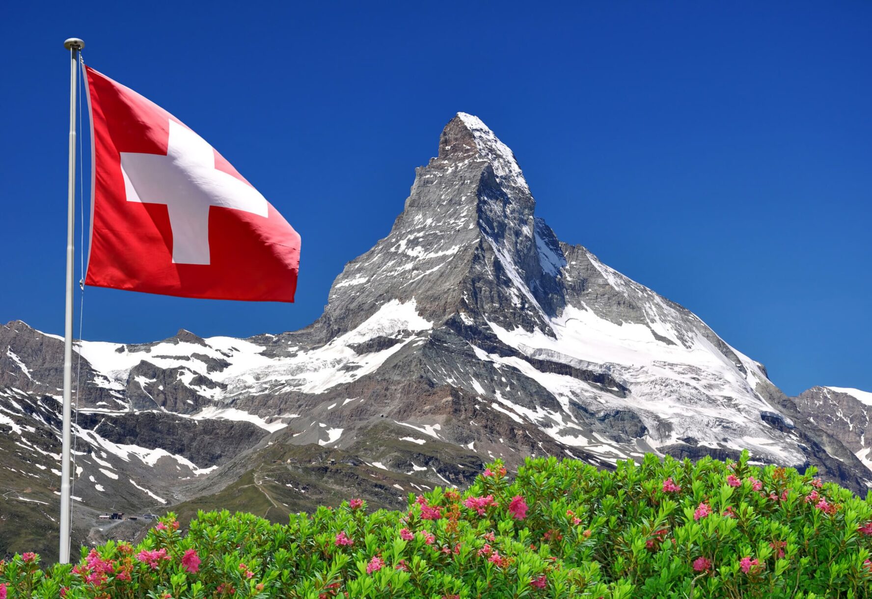 Swiss flag and Matterhorn in the backdrop