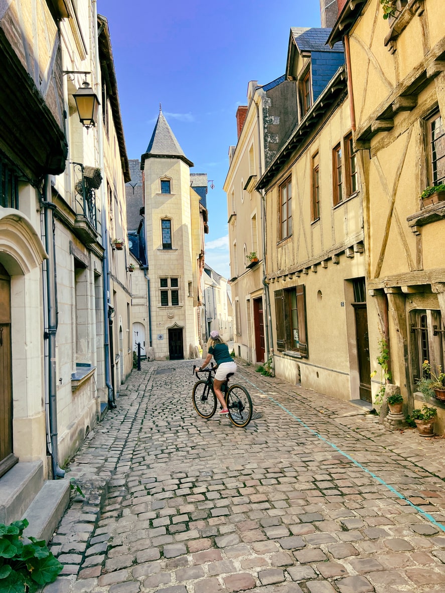 A woman cycling in Angers Chateau, France