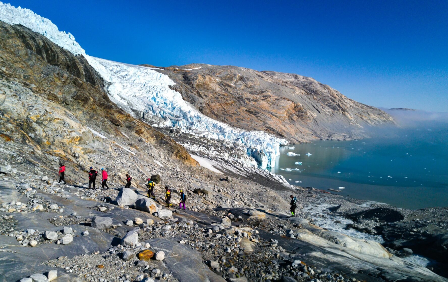 Hikers ascending a slope in Greenland