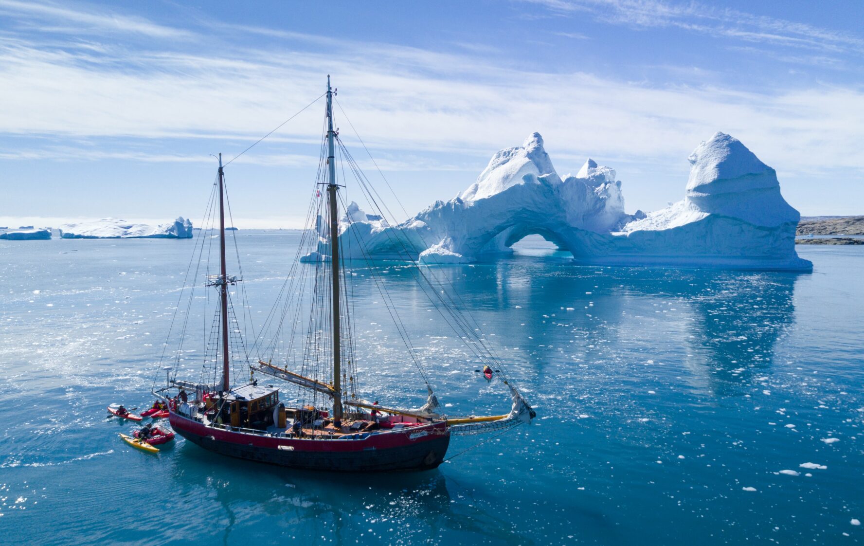 A sailing yacht near an iceberg in Greenland