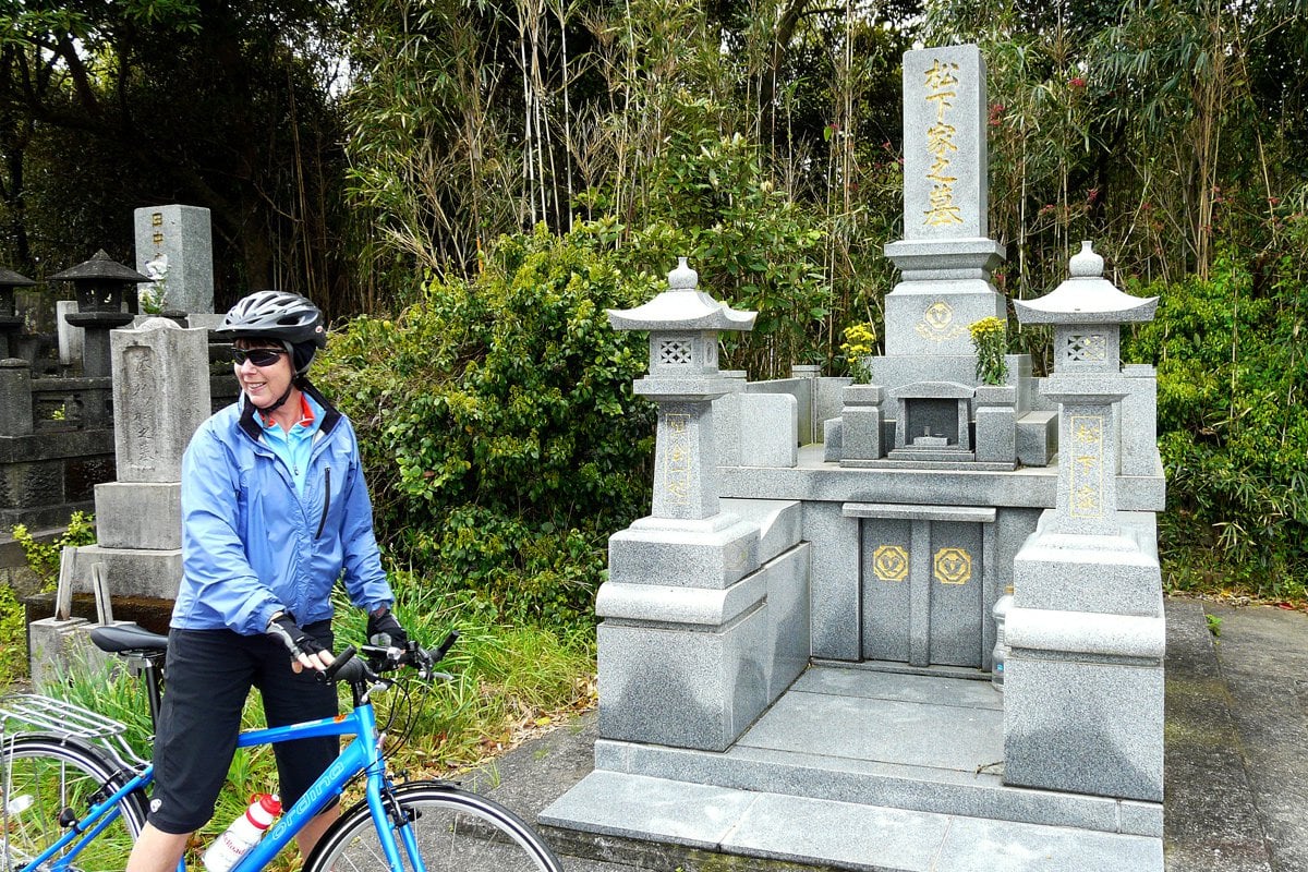 A cyclist near a temple in Japan