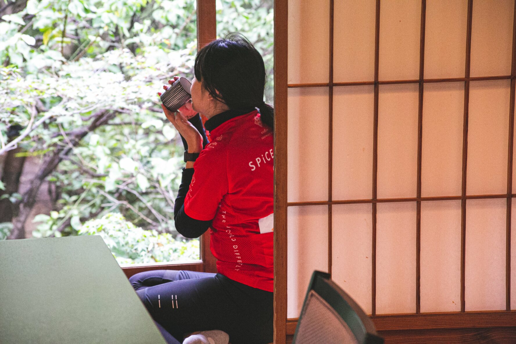 A biker drinking tea in a traditional tea house in Kyoto, Japan