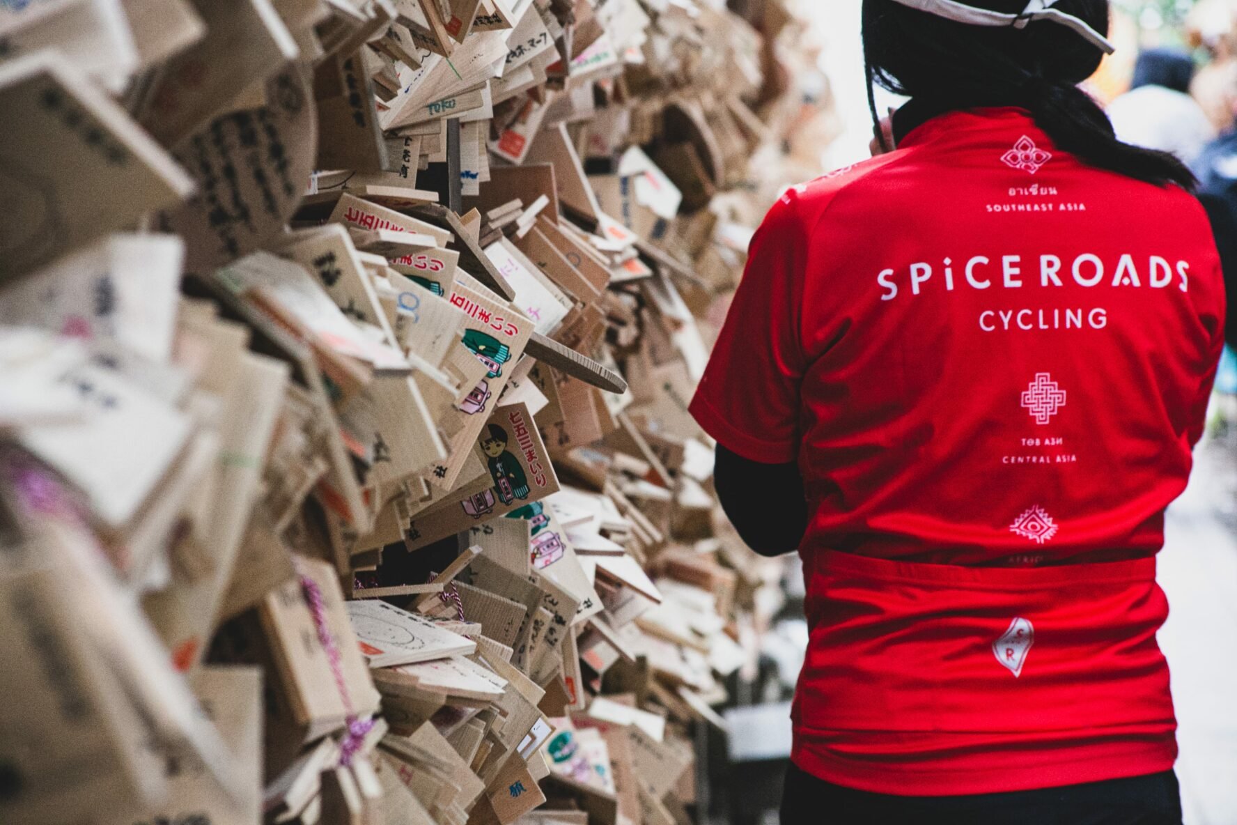 Biker posing near some cards in Kyoto, Japan