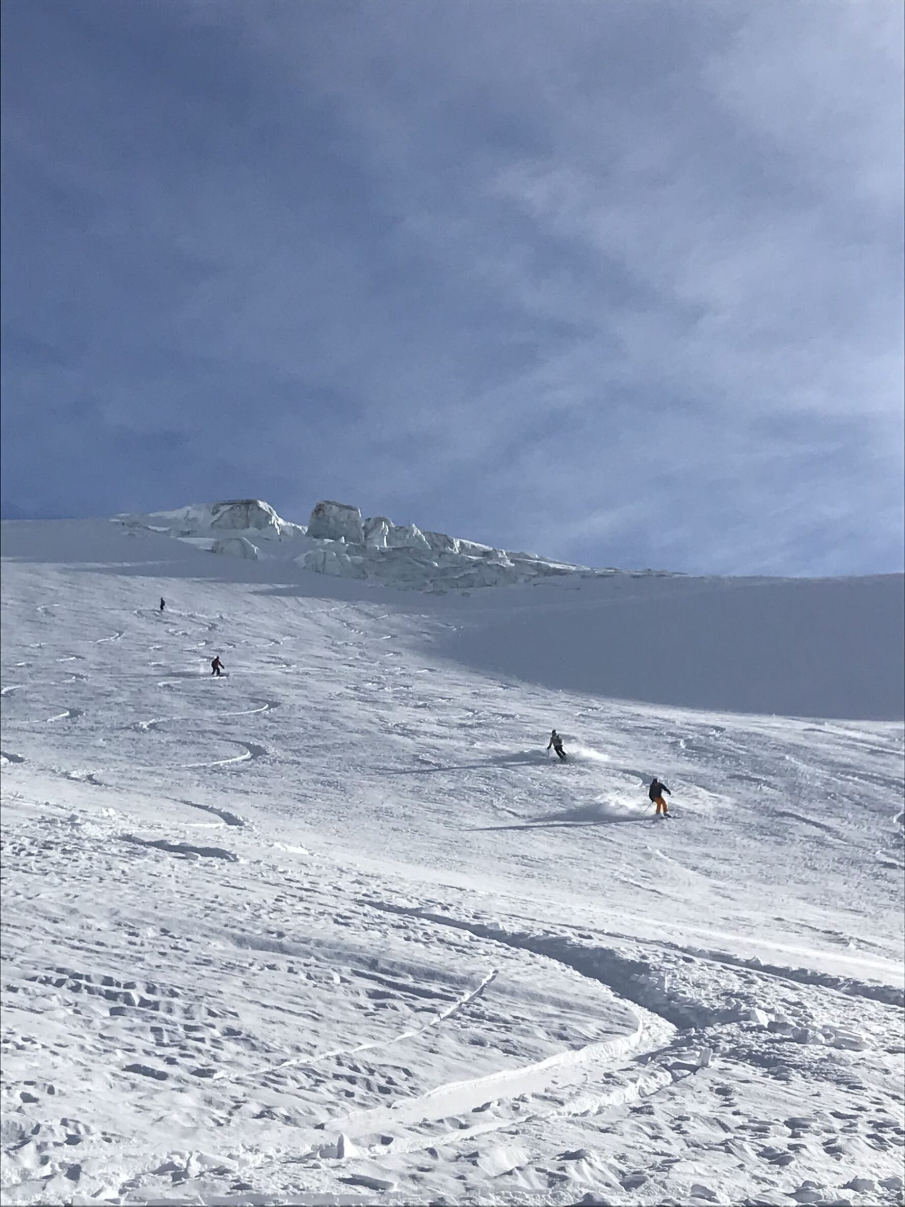 Skiers coming down a slope in Chamonix