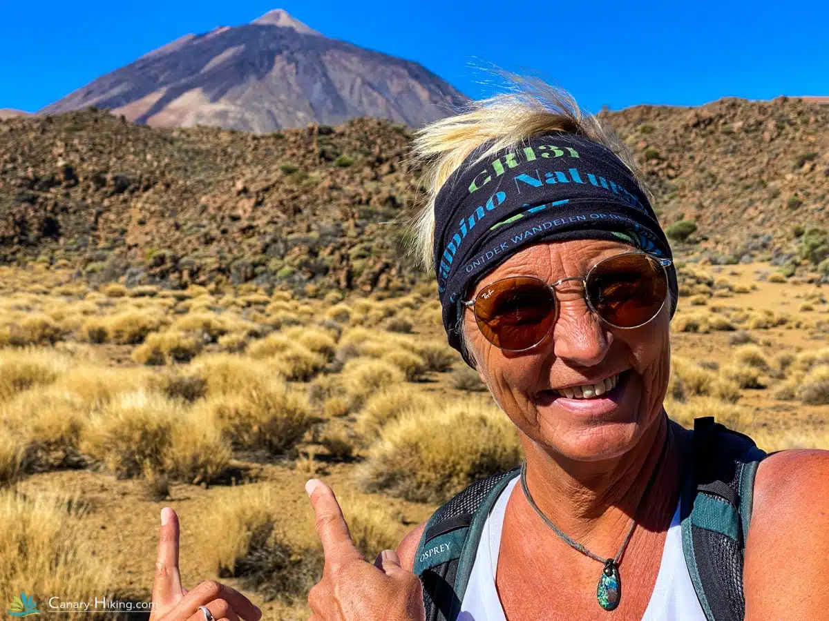 Older hiker posing in front of Pico del Teide peak in Tenerife