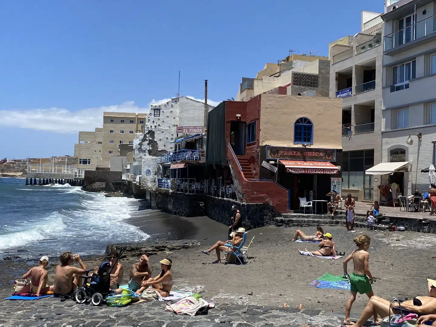 Families playing and sunbathing on a playa in Tenerife, Spain