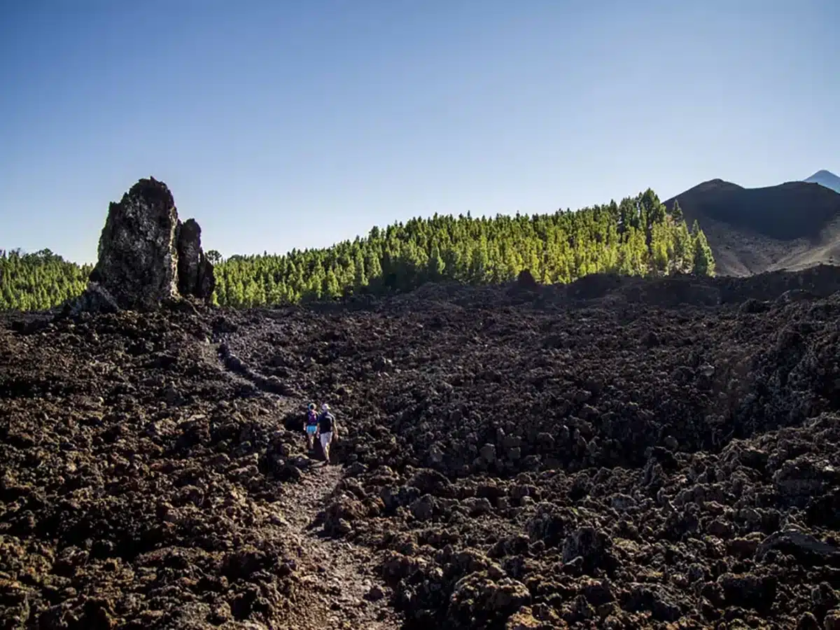 Hikers crossing the ridge of a volcano in Tenerife, Spain