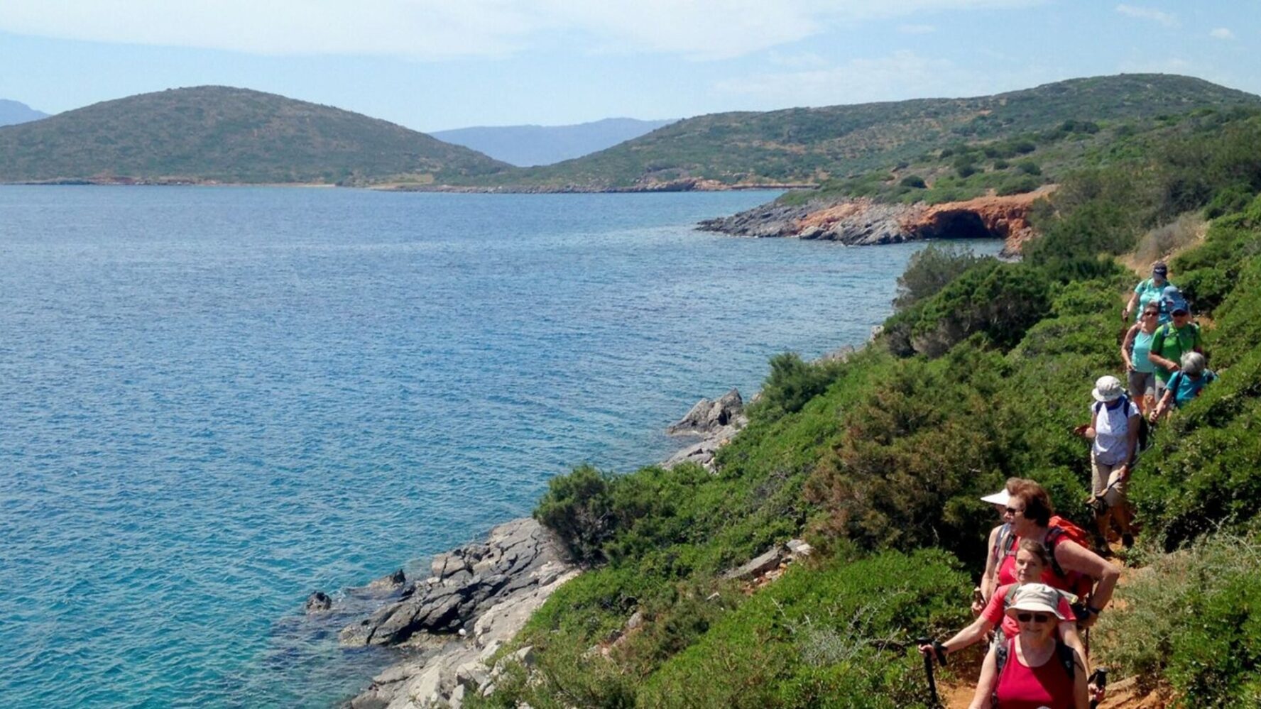 Hikers walking along a coastal trail with views of the Libyan Sea on Crete