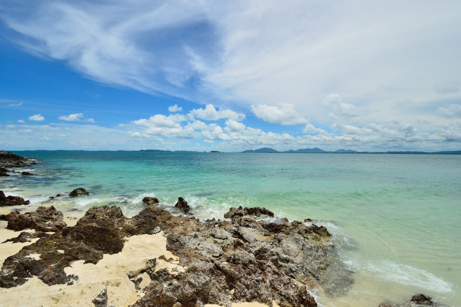 View of the sea from a white sand beach on Koh Talu, Thailand