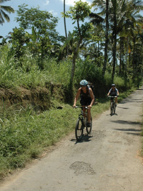 Bikers cycling through a field in Bali