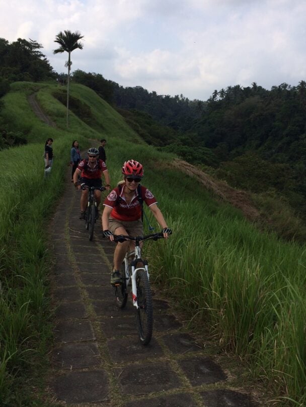 Bikers cycling through a field in Bali