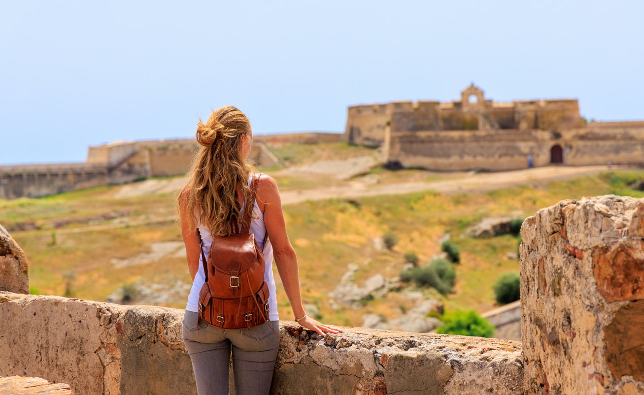 Castle Castro Marin and a hiker