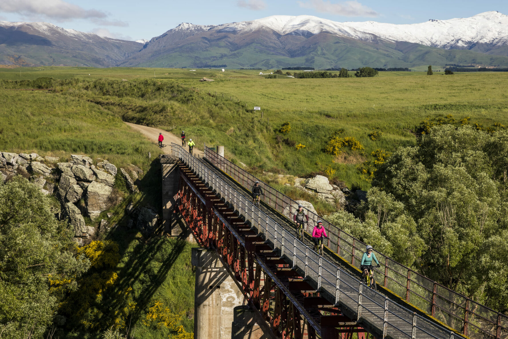 Cyclists crossing a bridge in Otago