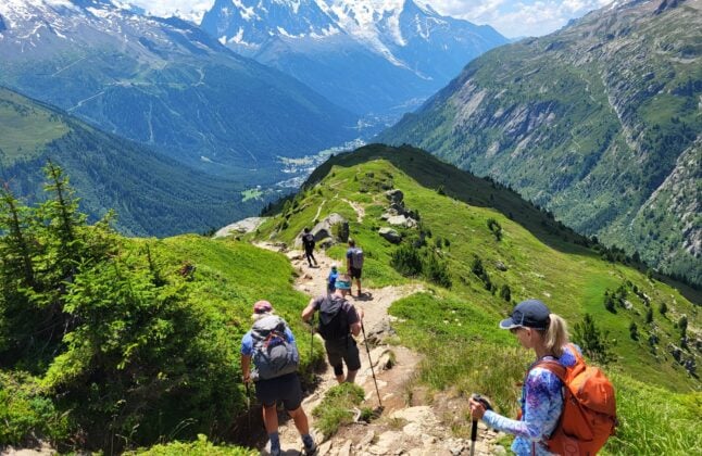 group hikers descending alps