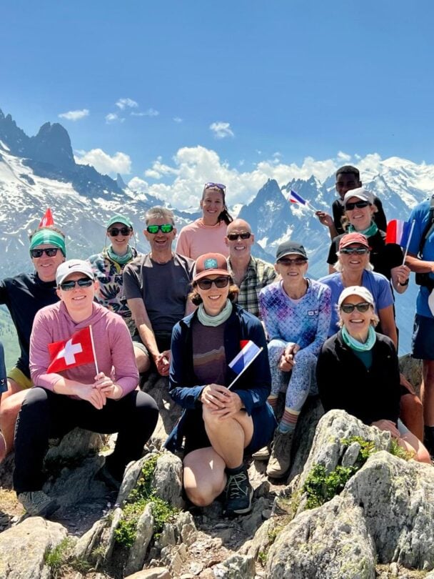 group hikers descending alps