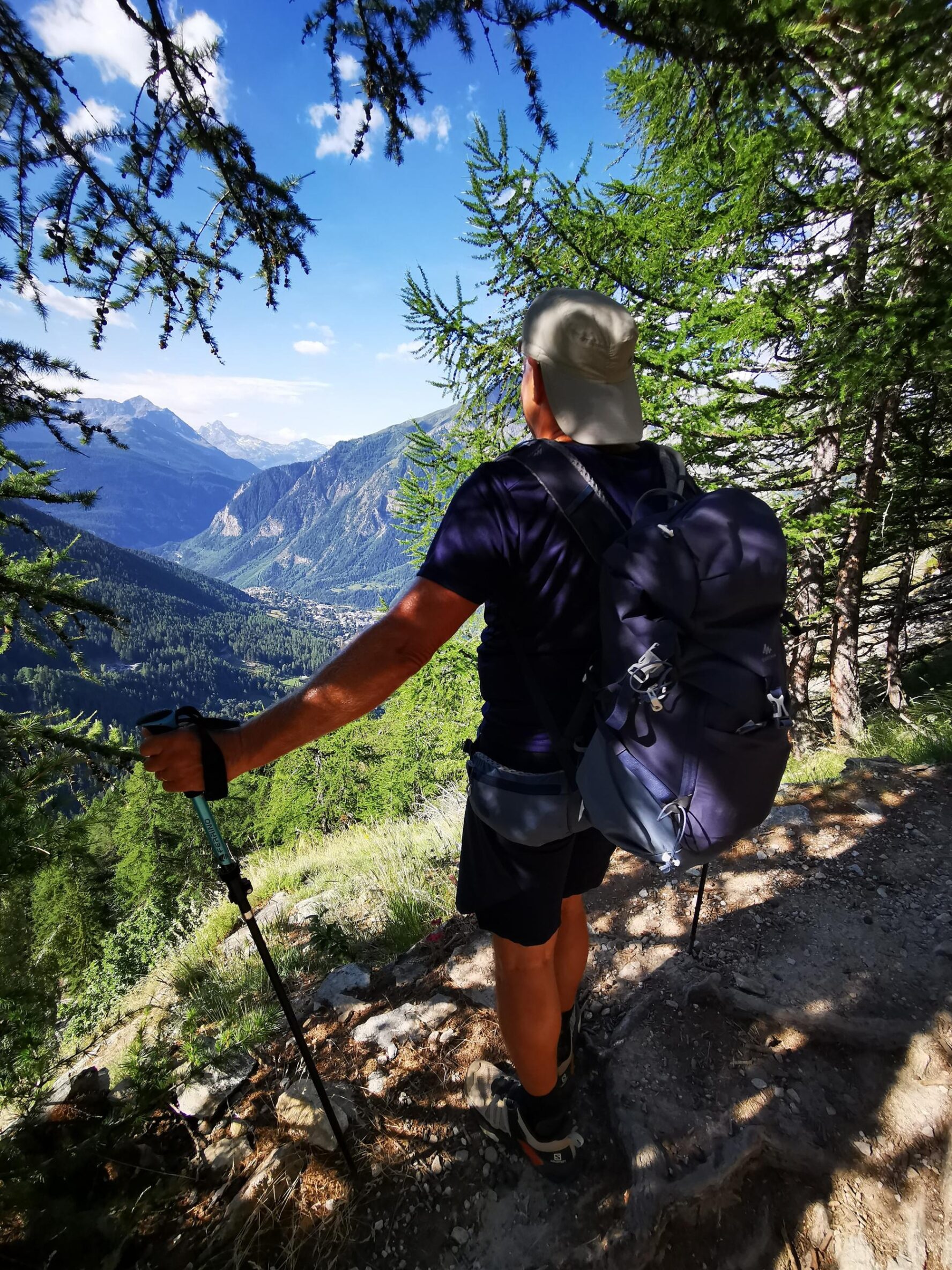 Hiker on a Tour du Mont Blanc trail overlooking a valley