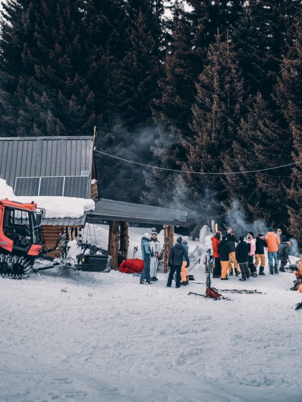 Giving the skis to skiers from a snowcat in Macedonia