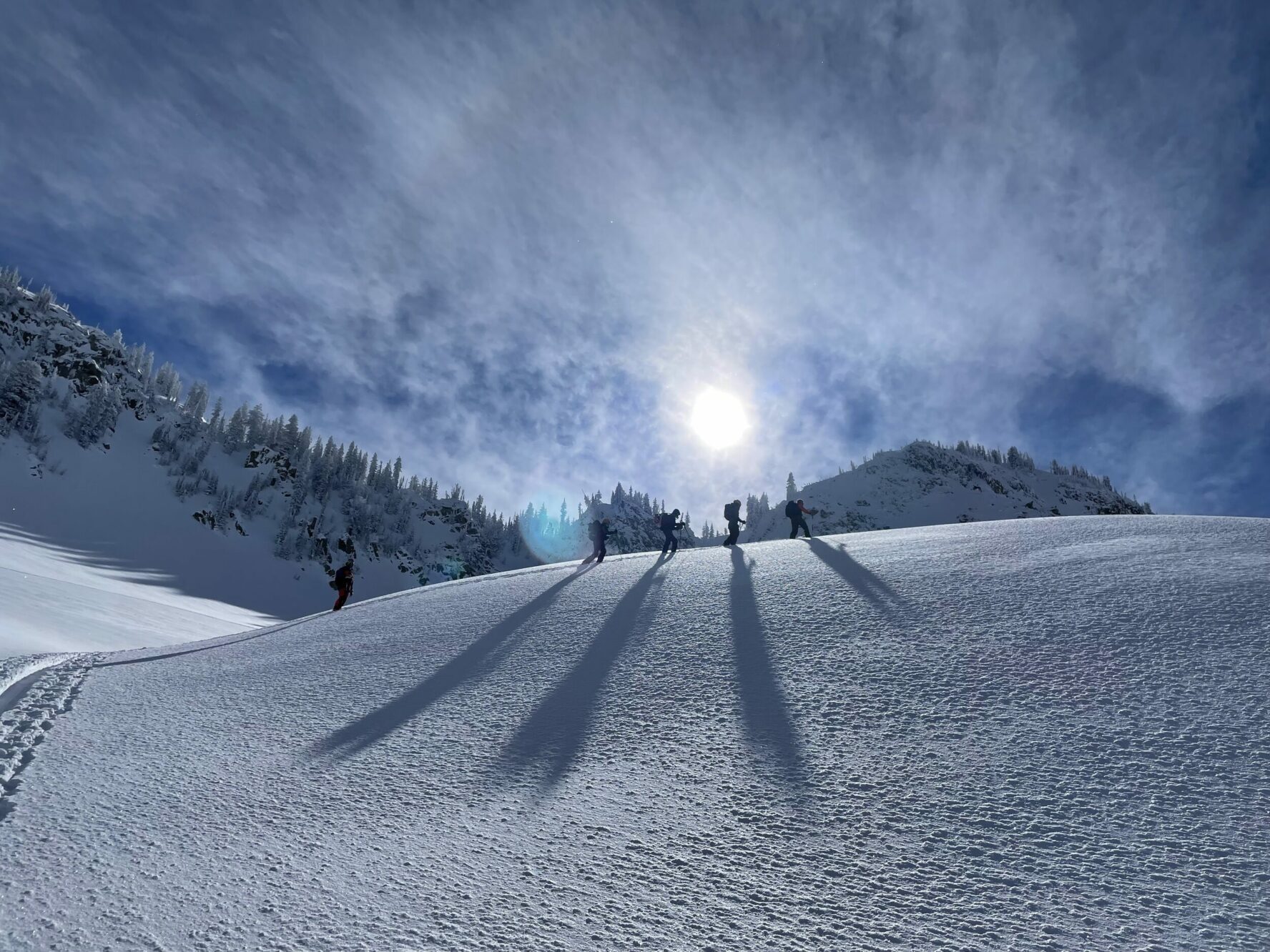 skiers-climbing-slope-sunny-day-utah